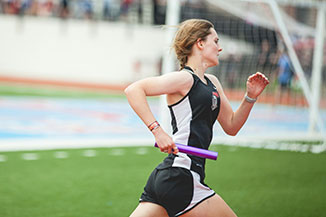 athlete-running Woman athlete running a baton race