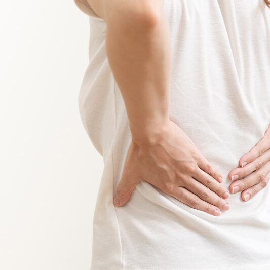 Woman with hands on lower back